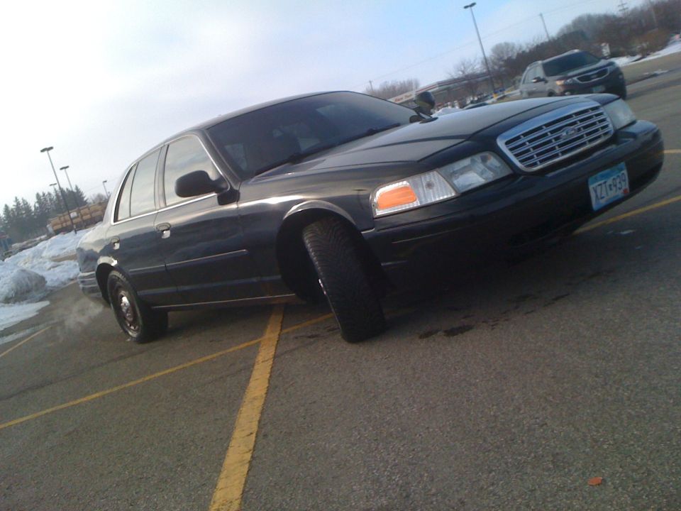 Black 2004 Ford Crown Victoria 3q-front view with a visible license plate