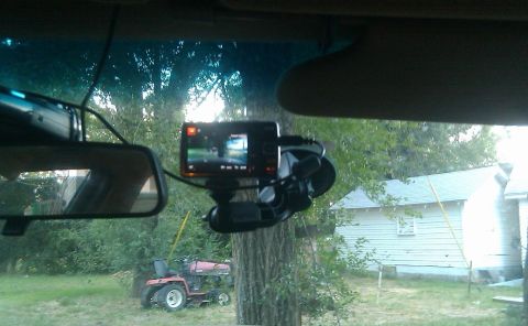 2000 Mercury Grand Marquis - View from inside a vehicle, showing a dashboard camera and rearview mirror.