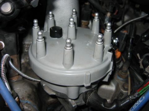 1992 Ford Bronco - Close-up view of a vehicle's distributor cap, showing the eight posts where spark plug wires connect.