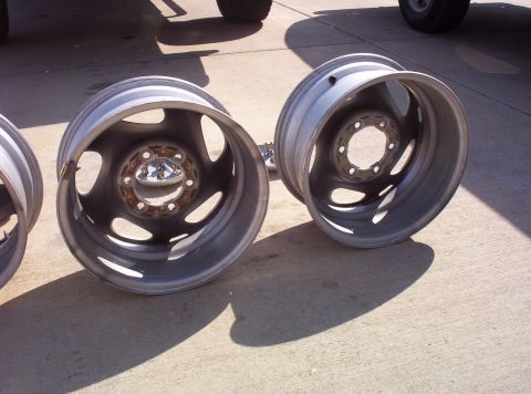 1988 Ford Bronco - Pair of aluminum alloy wheels, likely aftermarket, shown on a concrete surface.