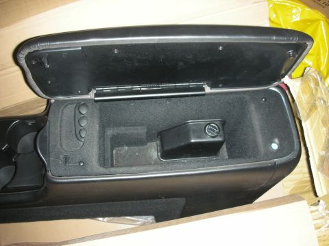 1998 Ford Crown Victoria - black automotive center console with its lid open, revealing the storage bin and cupholders, packed in a cardboard box.