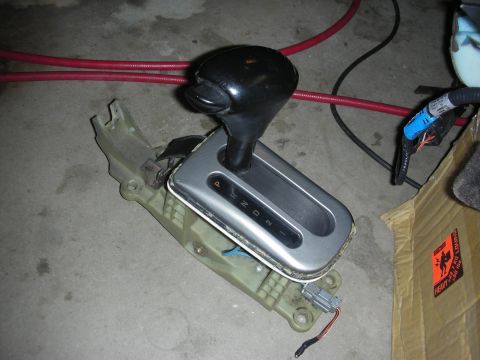 1998 Ford Crown Victoria - automatic transmission shifter with handle and PRND21 gate plate removed from its console, with wiring attached.