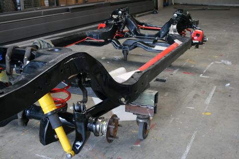 1973 Ford Ranchero - The chassis of a vehicle is shown on casters, with suspension components attached.