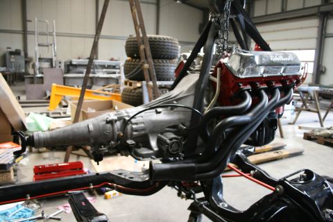 1973 Ford Ranchero - Engine and transmission assembly being worked on in a garage setting.