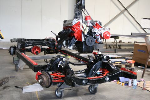 1973 Ford Ranchero - Engine and chassis assembly suspended by a hoist during a rebuild project.