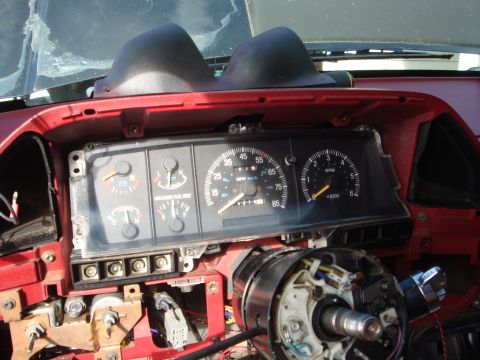 1989 Ford Bronco - The interior of a 1989 Ford Bronco shows the instrument cluster and steering column, with some disassembly apparent.