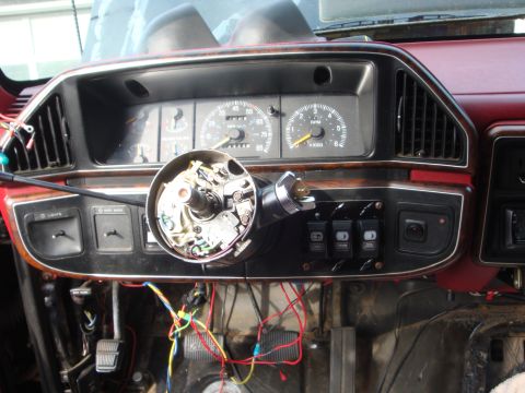 1989 Ford Bronco - The interior of a 1989 Ford Bronco shows a dashboard with exposed wiring and the steering column removed for repairs.