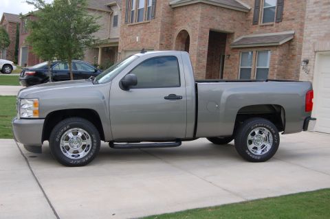 2007 Chevrolet Silverado 1500 - This 2007 Chevrolet Silverado 1500 pickup truck is shown from the side, parked in a driveway.
