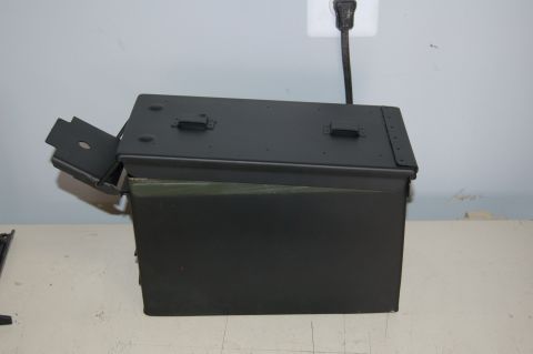2007 Chevrolet Silverado 1500 - A dark green metal toolbox is shown with its lid ajar, resting on a surface.