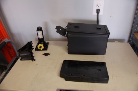 2007 Chevrolet Silverado 1500 - Various automotive parts and a metal box are laid out on a table, with a wall outlet visible in the background.
