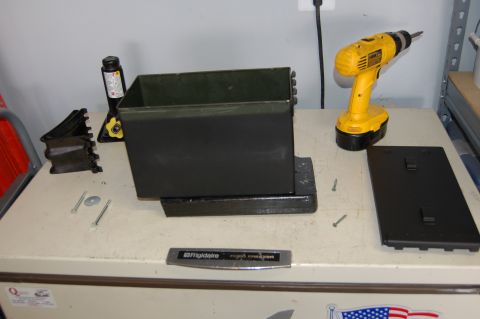 2007 Chevrolet Silverado 1500 - Parts laid out for a toolbox installation, including a drill and mounting hardware.