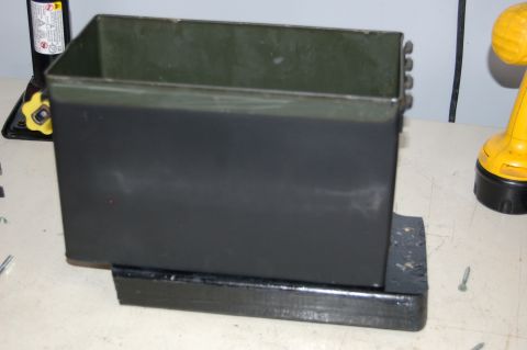 2007 Chevrolet Silverado 1500 - A black metal toolbox is shown mounted on a wooden block, with tools visible in the background.