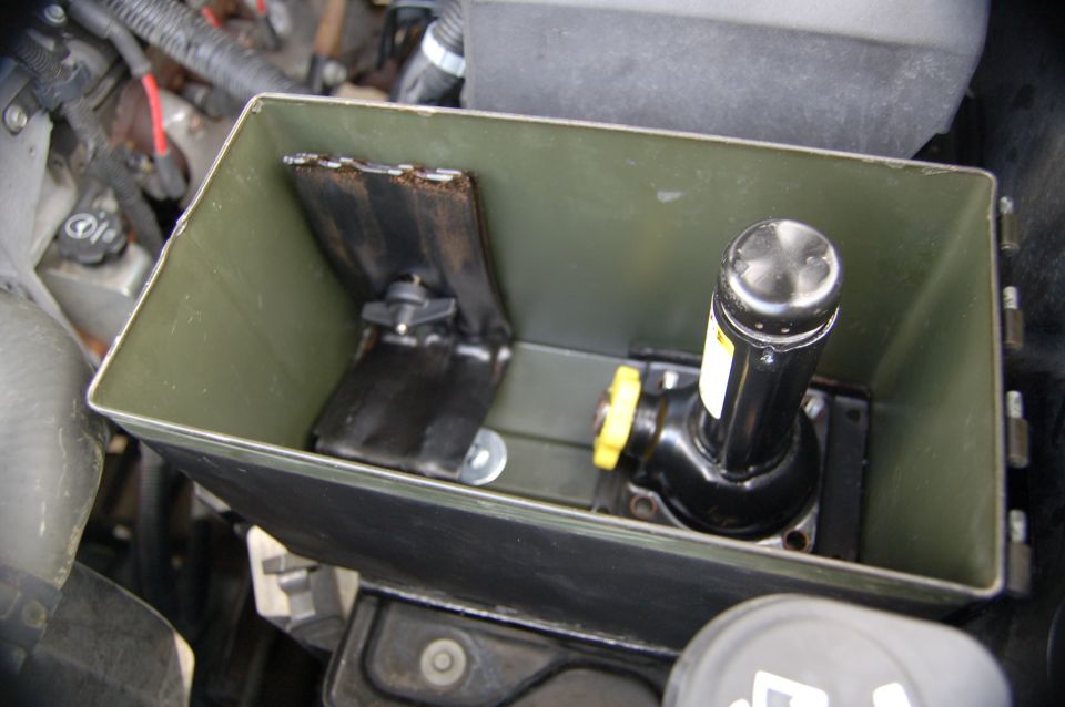Ammo can with jack and bracket inside, mounted in engine bay