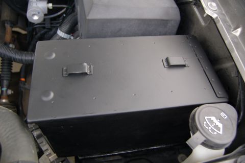 2007 Chevrolet Silverado 1500 - Engine bay view of a black toolbox with latches, positioned near hoses and a fluid reservoir cap.