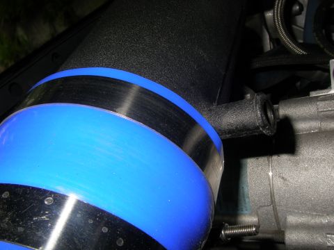 1990 Ford Bronco - A close-up view of an engine part, possibly an intake or filter housing, with blue and black accents.