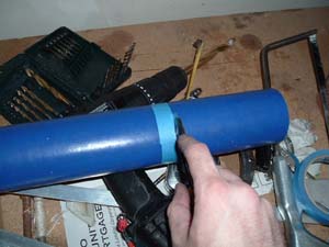 1990 Ford Bronco - A blue pipe is being taped, with a drill and other tools visible in the background.