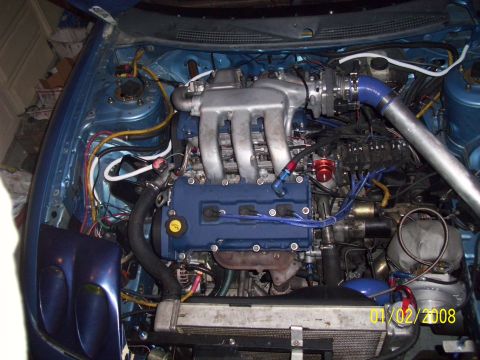 1995 Ford Probe - Custom engine bay modifications visible, including a turbocharger and aftermarket intake.