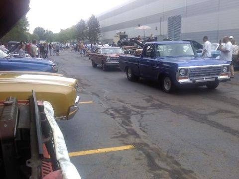 1970 Ford Ranchero - A blue pickup truck is parked in a lot with several other cars visible.
