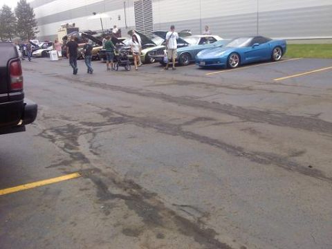 1970 Ford Ranchero - A gathering of vehicles and people in a parking lot, with a blue Corvette prominently displayed.