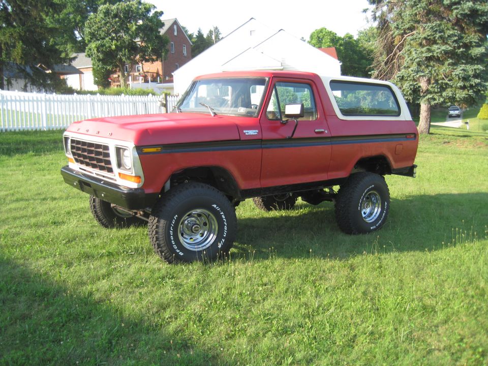 1979 Ford Bronco, red with white top, lifted suspension, chrome wheels