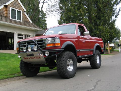 1989 Ford Bronco - This lifted 1989 Ford Bronco features a custom off-road bumper with auxiliary lights and large, aggressive tires.