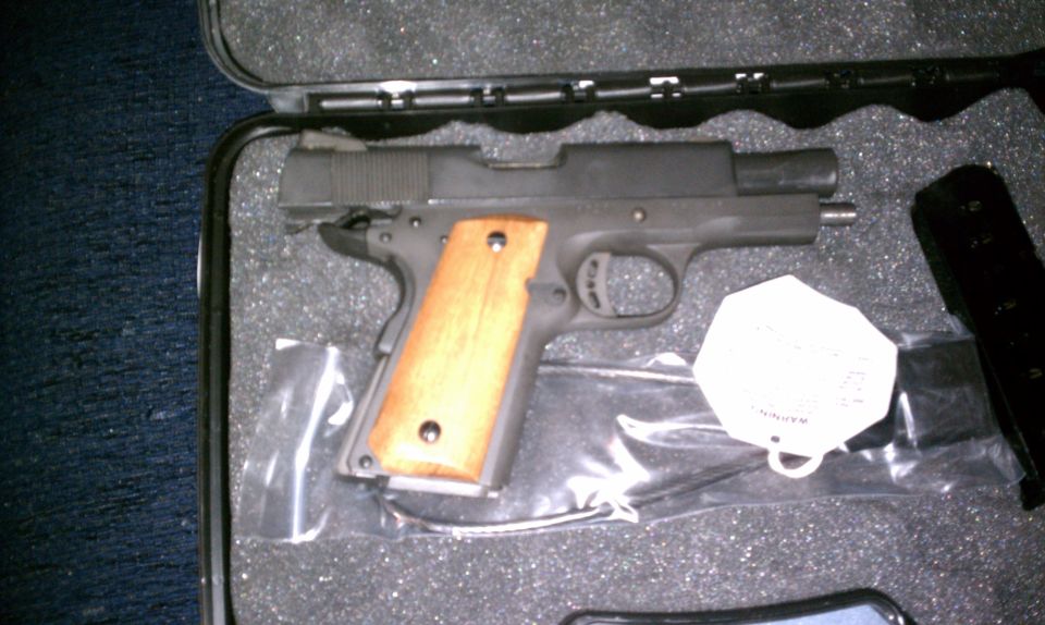 Pistol with wooden grips in a black case with foam padding