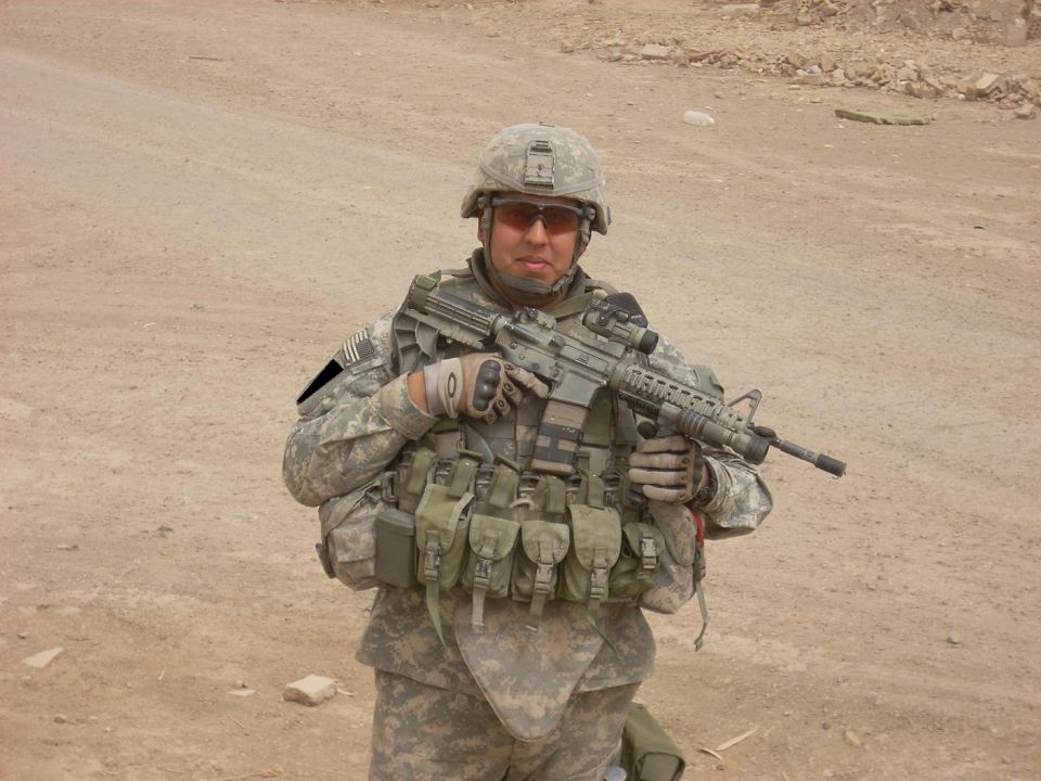 Soldier in camouflage holding an assault rifle