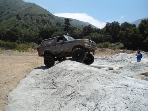 1994 Ford Bronco - A modified Ford Bronco navigates a rocky terrain, its off-road capabilities.