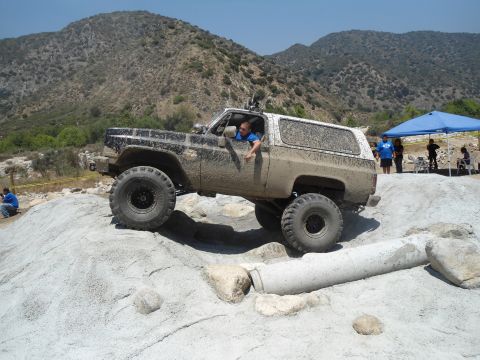 1994 Ford Bronco - This heavily modified SUV is shown off-roading on a sunny day.