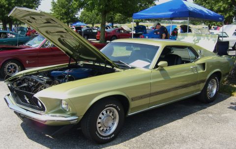 2007 Ford Mustang - A lime green 1969 Ford Mustang Mach 1 is displayed with its hood open at an outdoor car show.