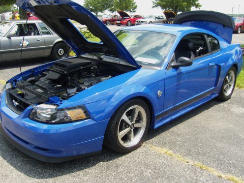 2007 Ford Mustang - A blue Ford Mustang is displayed with its hood and trunk open, revealing the engine compartment.
