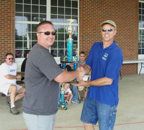 2007 Ford Mustang - Two men are presented with a trophy at an outdoor event.