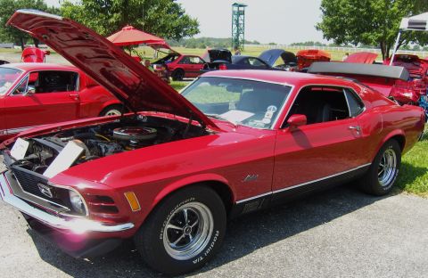 2007 Ford Mustang - A red 1970 Ford Mustang Mach 1 is displayed with its hood open at an outdoor event.