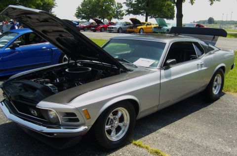 2007 Ford Mustang - A silver 1970 Ford Mustang is displayed with its hood open, alongside other vehicles at an outdoor car show.
