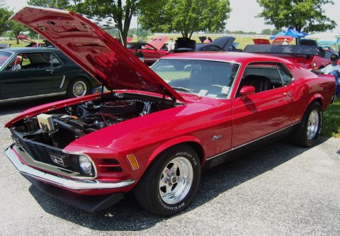 2007 Ford Mustang - A red 1970 Ford Mustang Mach 1 is displayed with its hood open at a car show.