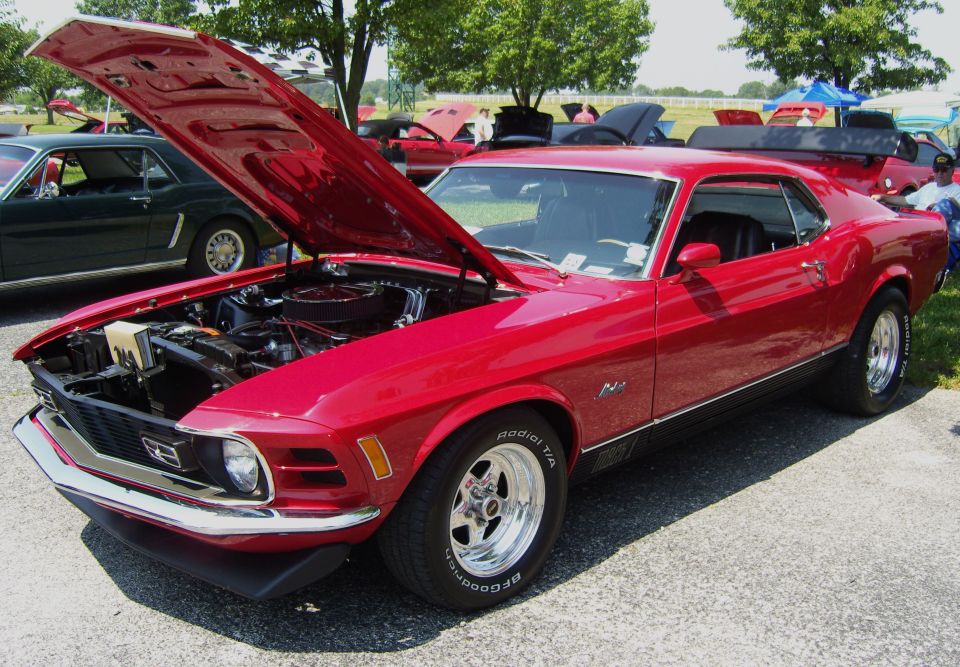 Red 1970 Ford Mustang Mach 1 with hood open, showing engine