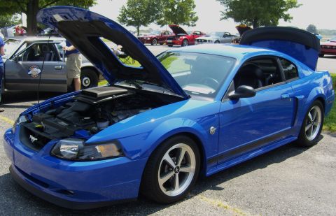 2007 Ford Mustang - Blue 2007 Ford Mustang coupe at an outdoor car show, hood and trunk open.