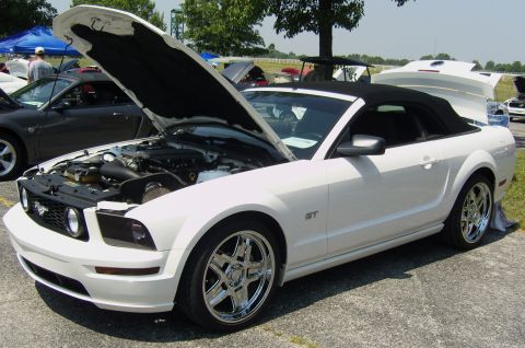 2007 Ford Mustang - A white convertible Ford Mustang GT is shown with its hood and trunk open, parked on asphalt.