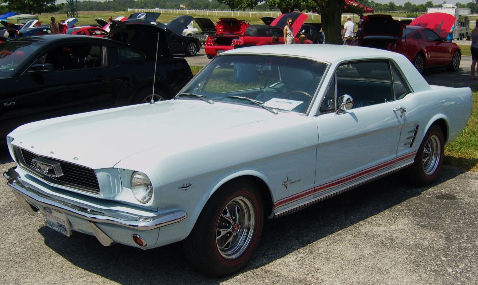 Light blue 1965 Ford Mustang coupe with red stripe on rocker panel