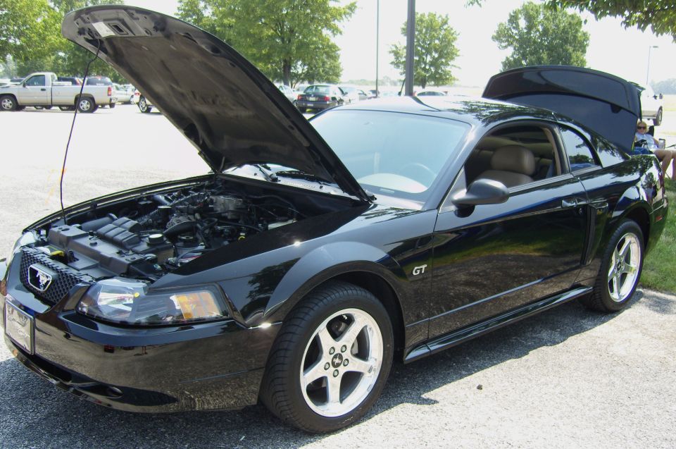 Black 2007 Ford Mustang GT with hood and trunk open, parked outside