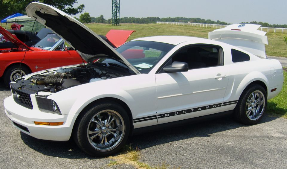 White 2007 Ford Mustang with hood and trunk open, side view