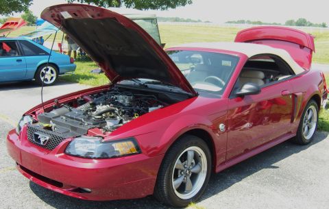 2007 Ford Mustang - A red convertible Mustang is displayed with its hood and trunk open, revealing the engine and interior.