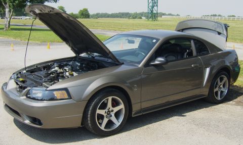 2007 Ford Mustang - 2007 Ford Mustang coupe with hood and trunk open, parked outdoors on a paved surface.