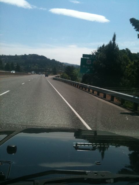 2005 Jeep Wrangler - View from the hood of a black Jeep Wrangler driving on a highway, with a sign indicating exit 30 for Mosier.