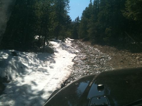 2005 Jeep Wrangler - Driving a Jeep Wrangler on a rough forest road with snow on the side.