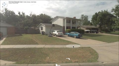 2000 Mercury Grand Marquis - A silver 2000 Mercury Grand Marquis and a blue sedan are parked in the driveway of a suburban home.