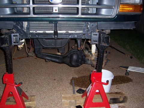 1992 Ford Bronco - Front axle and suspension of a 1992 Ford Bronco are supported by jack stands.