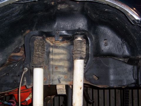 1992 Ford Bronco - Close-up view of the rear suspension components, including shocks and protective bellows.