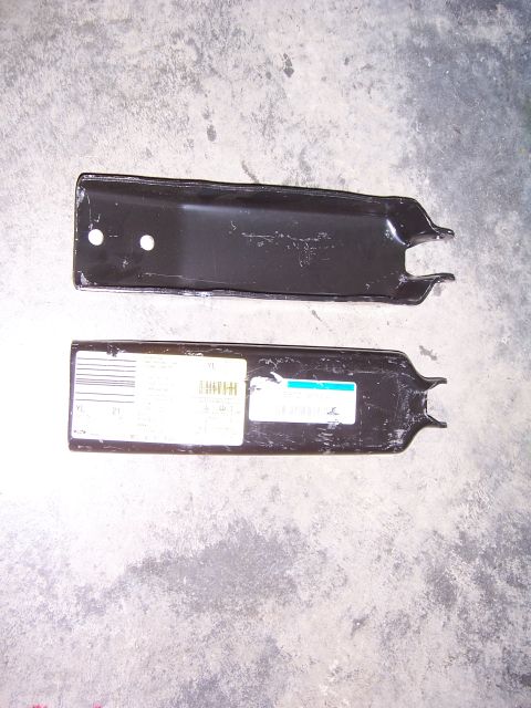 1992 Ford Bronco - Two black metal brackets are shown against a concrete background, with labels visible on the lower bracket.