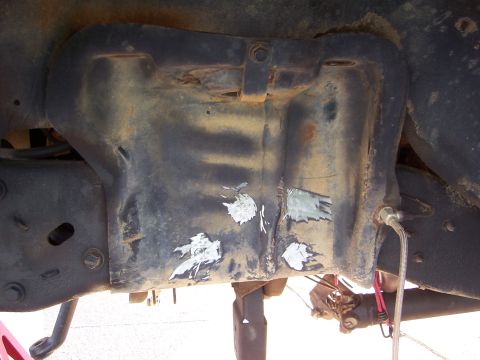 1992 Ford Bronco - Close-up of an underbody component showing signs of repair with white patches and a SuperMotors watermark.